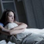 Donna seduta sul letto