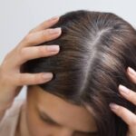 donna con le mani in testa su capelli grigi