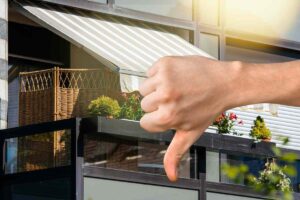 Balcone con tenda da sole e pollice in giù