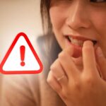 sfondo ragazza che mangia le unghie e cartello triangolare segnale pericolo