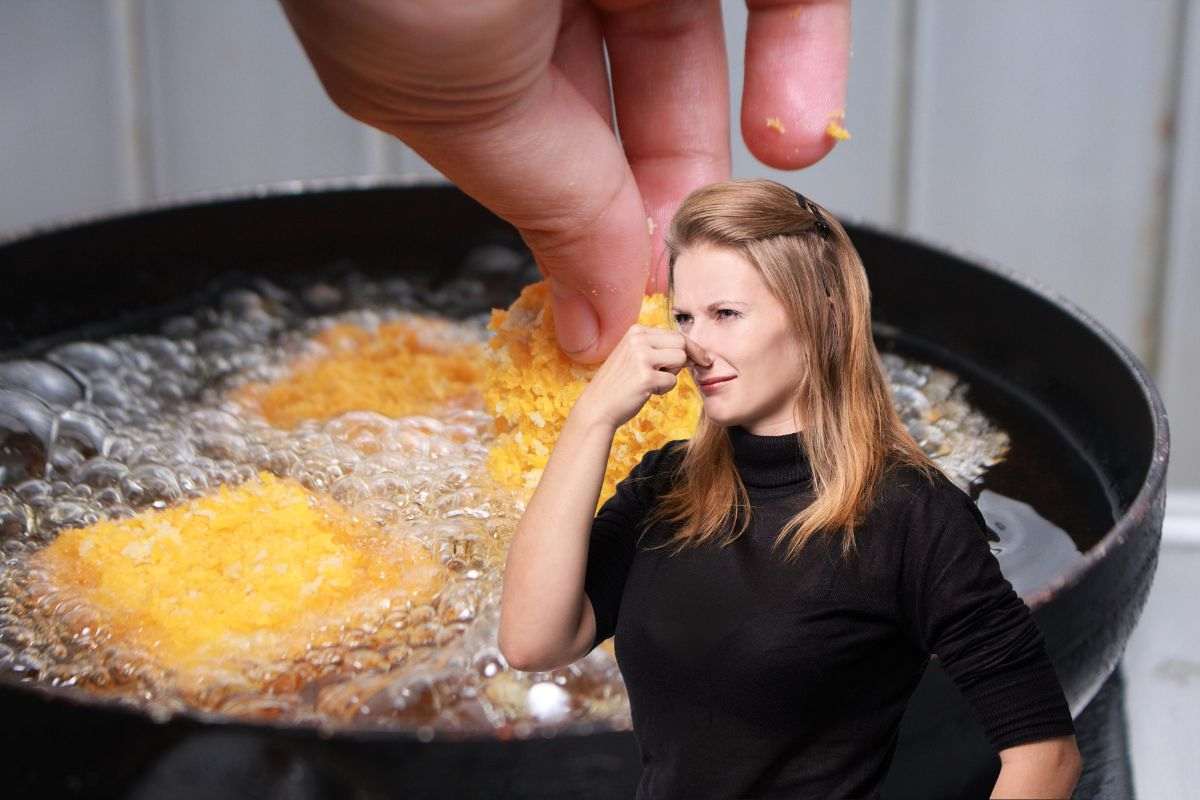 donna che si tappa il naso per la puzza di frittura